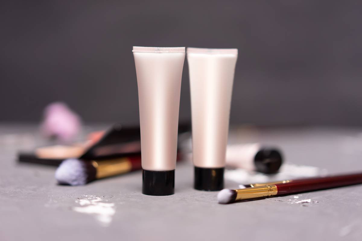 woman applying lip volume potion with precision brush for defined plump effect